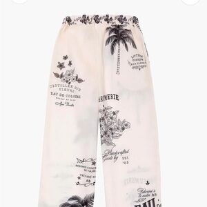 Agua Bendita Kids Diana Printed Wide-Leg Pants in Cream with Black Script